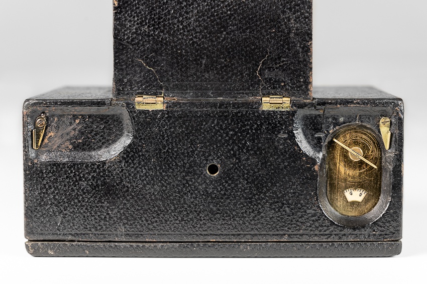Bottom of Flat Folding Kodak showing winding key and back locks.
